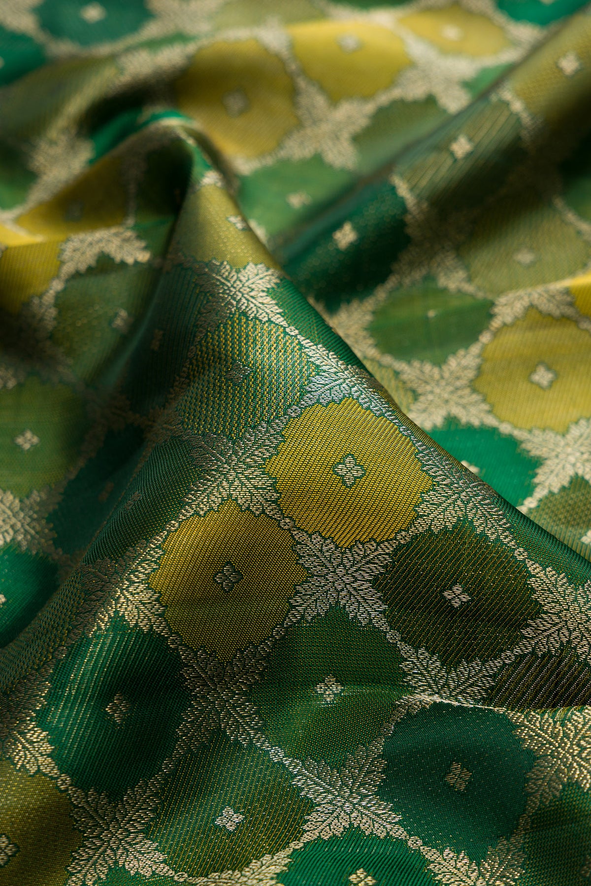 Close up of Pure Silk Bottle Green Kanjivaram Saree with Zari Brocade on the body and Zari Border.  displaying folds