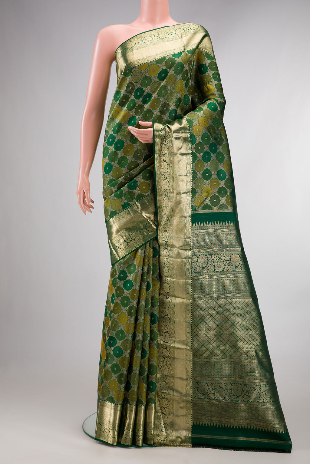 Pure Silk Bottle Green Kanjivaram Saree with Zari Brocade on the body and Zari Border.  displayed on a mannequin