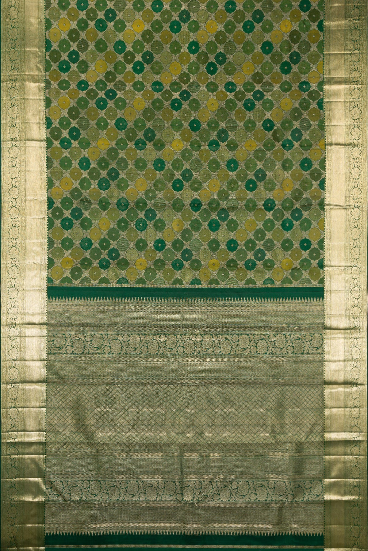 Flat view of Pure Silk Bottle Green Kanjivaram Saree with Zari Brocade on the body and Zari Border. 