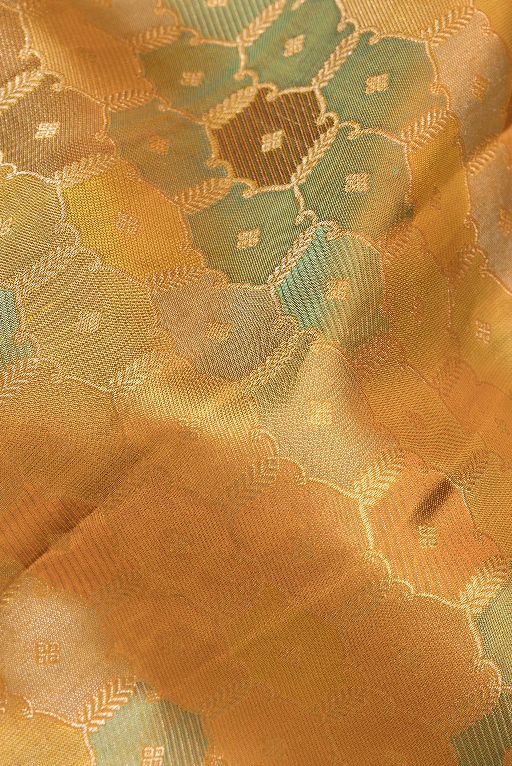 Close up of Pure Silk Mustard Kanjivaram Saree with Zari Brocade on the body and Zari Border.  displaying folds