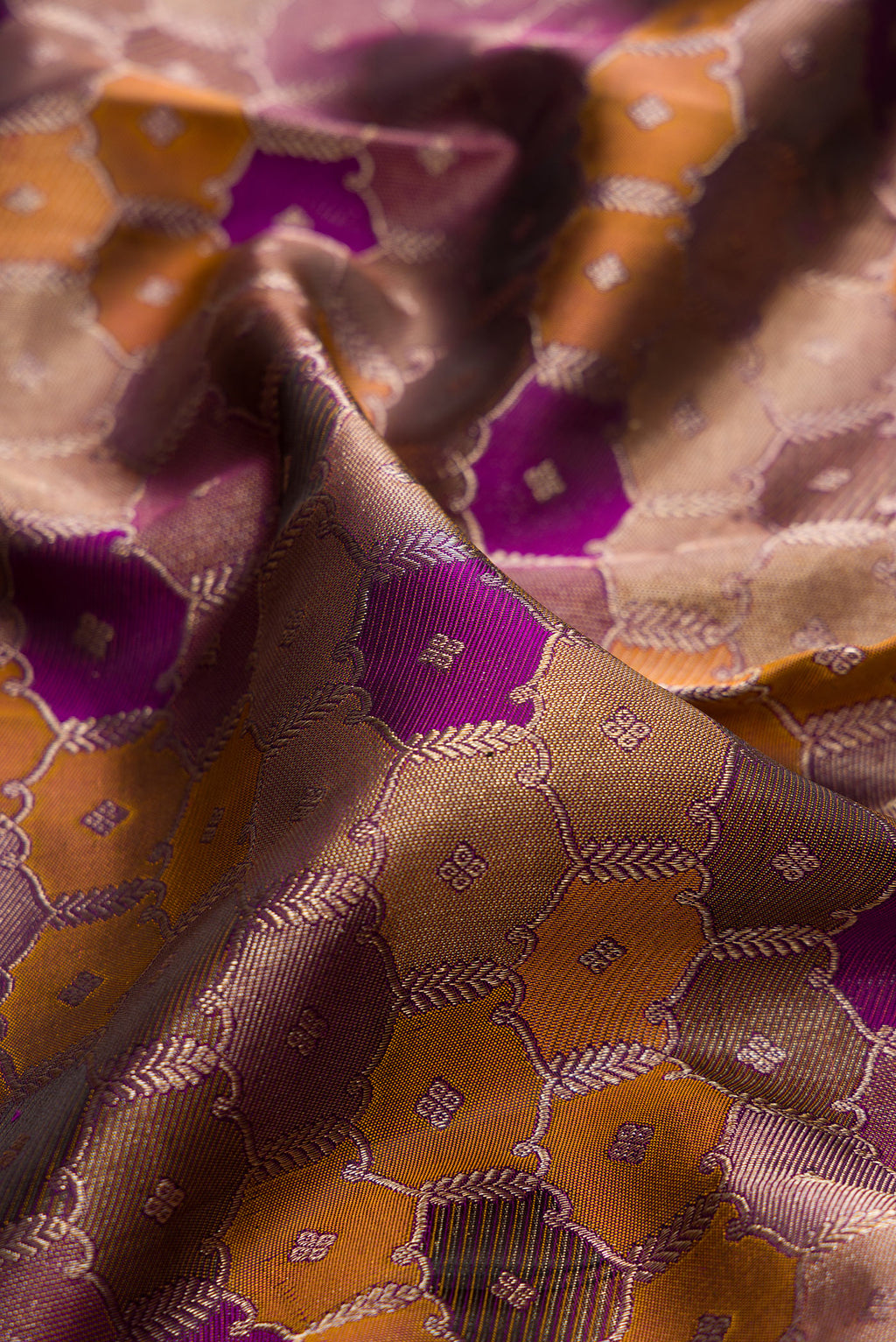 Close up of Pure Silk Purple Dual Tone Kanjivaram Saree with Zari Brocade on the body and Zari Border.  displaying folds