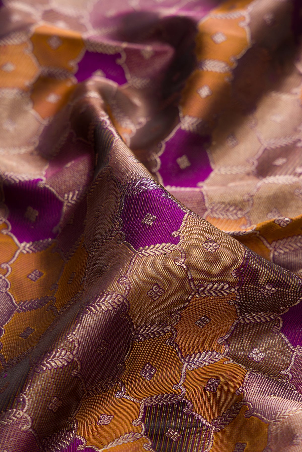 Close up of Pure Silk Purple Dual Tone Kanjivaram Saree with Zari Brocade on the body and Zari Border.  displaying folds