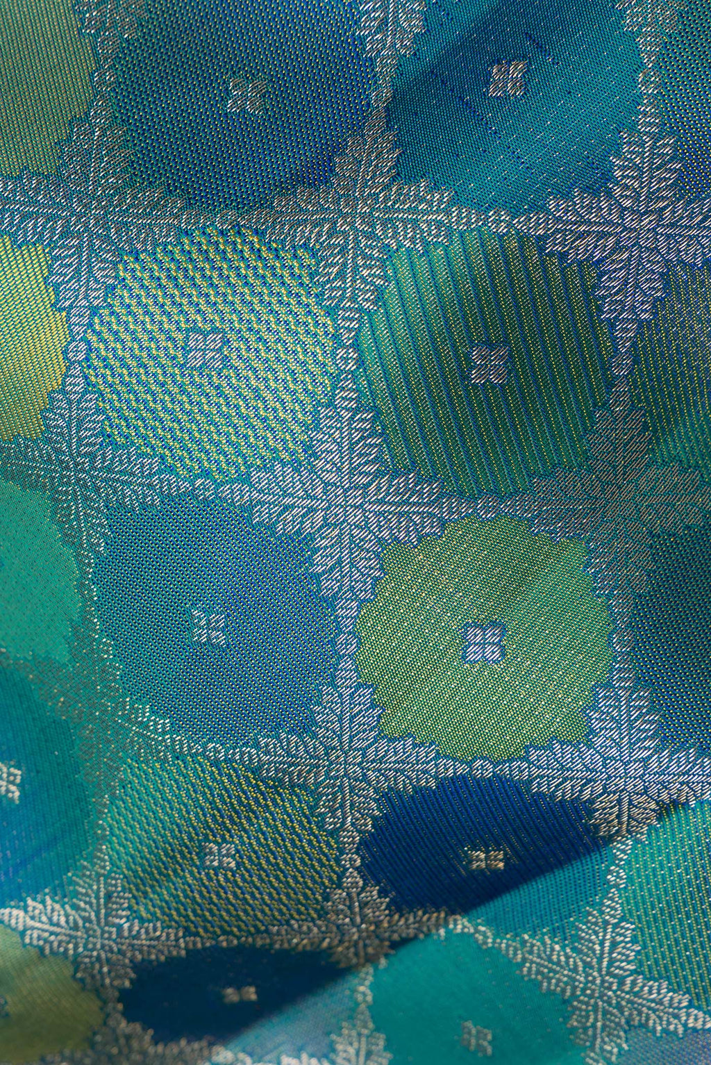 Close up of Pure Silk Peacock Blue Dual Tone Kanjivaram Saree with Zari Brocade on the body and Zari Border.  displaying folds