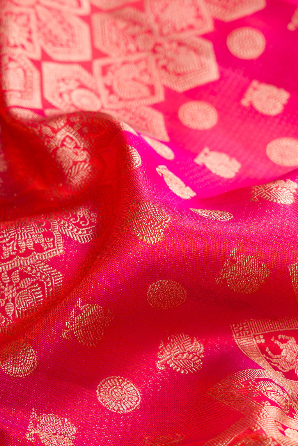 Close up of Pure Silk Pink and Orange Color Kanjivaram Saree with Zari Brocade on the body and Fancy Border.  displaying folds