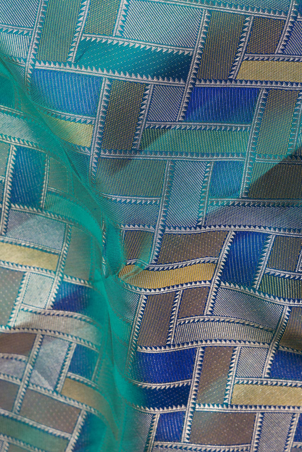 Close up of Pure Silk Peacock Blue Dual Tone Kanjivaram Saree with Zari Brocade on the body and Zari Border.  displaying folds