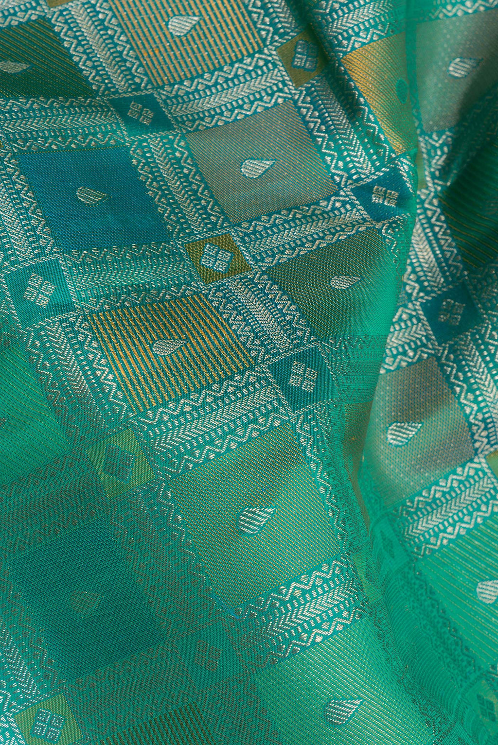 Close up of Pure Silk Peacock Blue Dual Tone Kanjivaram Saree with Zari Brocade on the body and Zari Border.  displaying folds