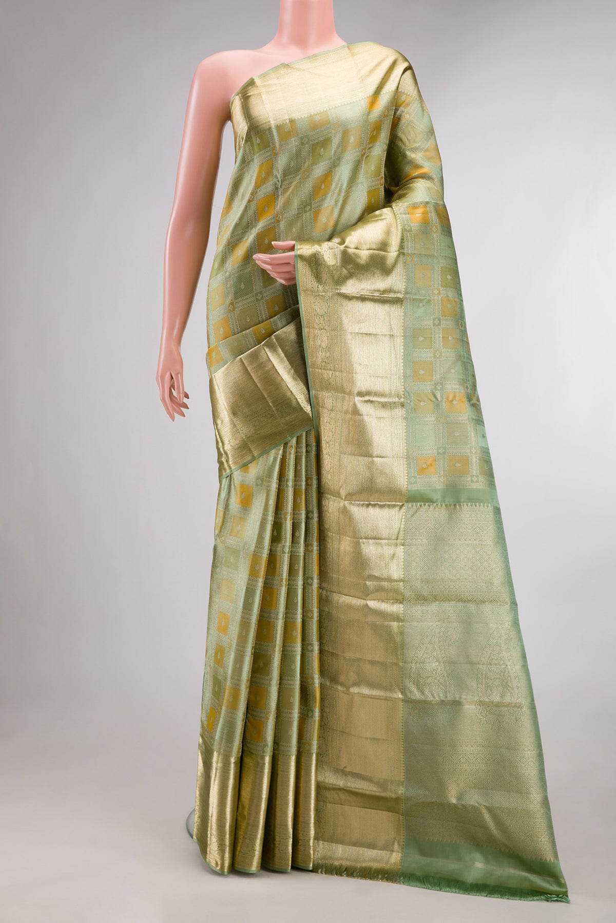 Pure Silk Pista Green Kanjivaram Saree with Zari Brocade on the body and Zari Border.  displayed on a mannequin