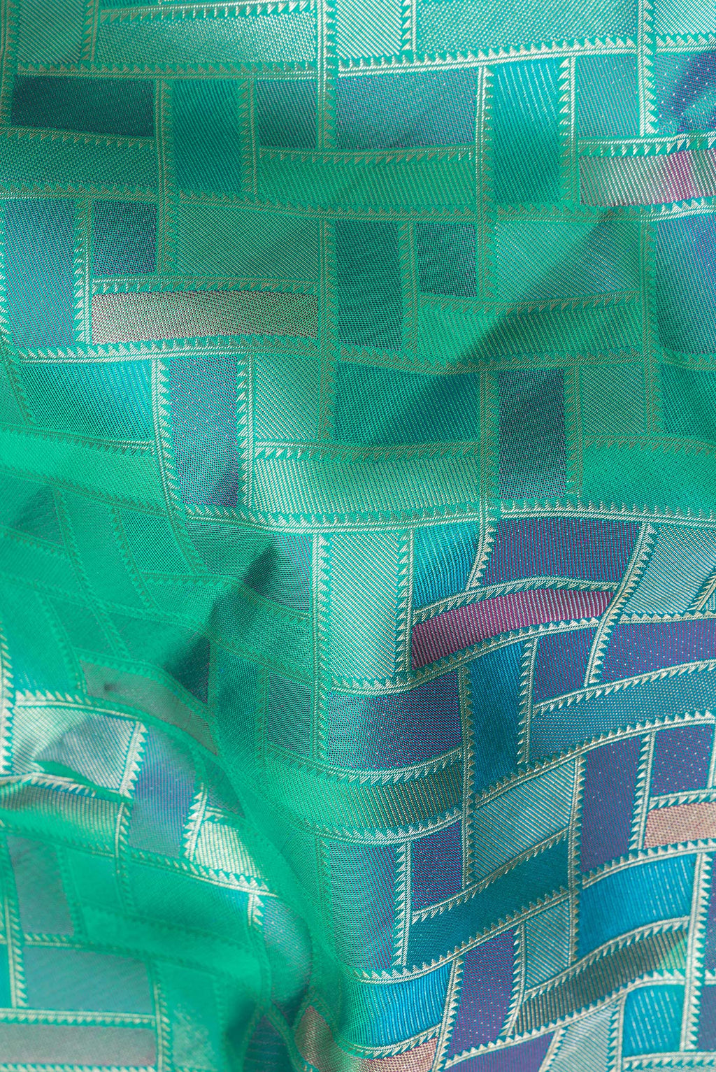 Close up of Pure Silk Sea Green Dual Tone Kanjivaram Saree with Zari Brocade on the body and Fancy Border.  displaying folds