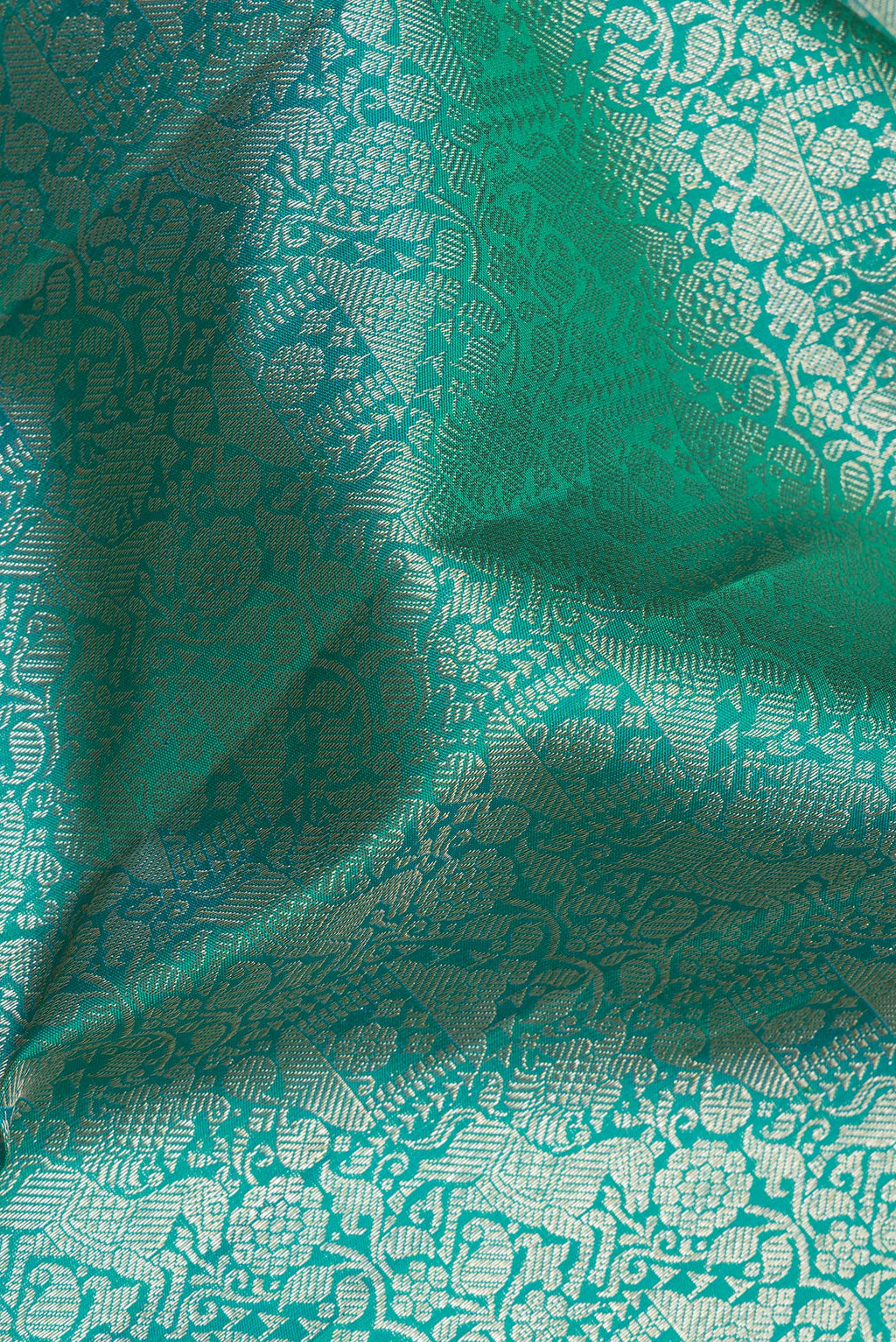 Close up of Pure Silk Sea Green Dual Tone Kanjivaram Saree with Zari Brocade on the body and Fancy Border.  displaying folds