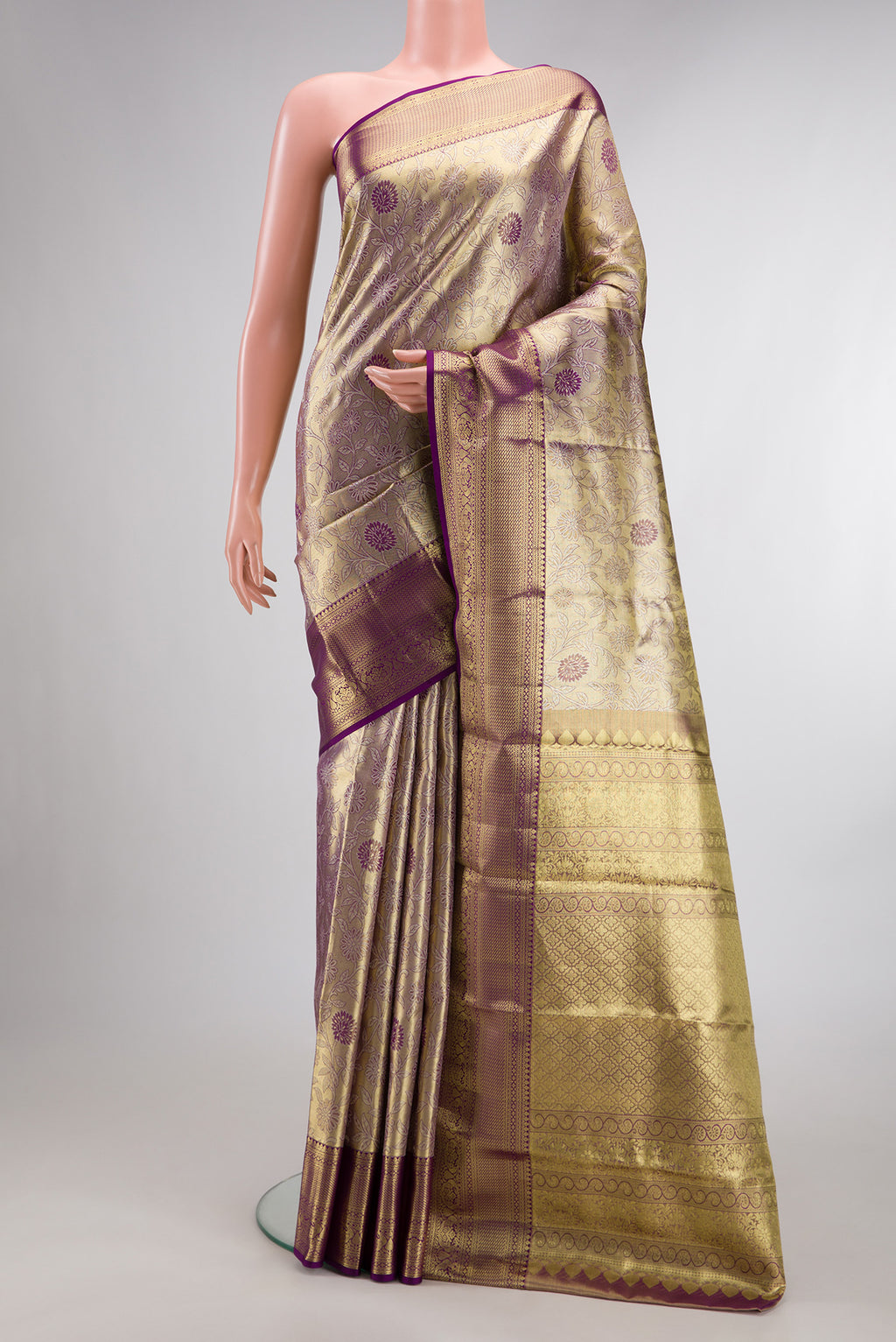 Gold Dual Tone Kanchipuram Tissue Saree with Zari Brocade on the body and Zari Border.  displayed on a mannequin