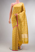 Pure Silk Yellow Banarasi Saree with Zari Brocade on the body and Zari Border.  displayed on a mannequin