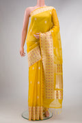 Pure Silk Yellow Dual Tone Organza Saree with Zari Butta on the body and Zari Border.  displayed on a mannequin