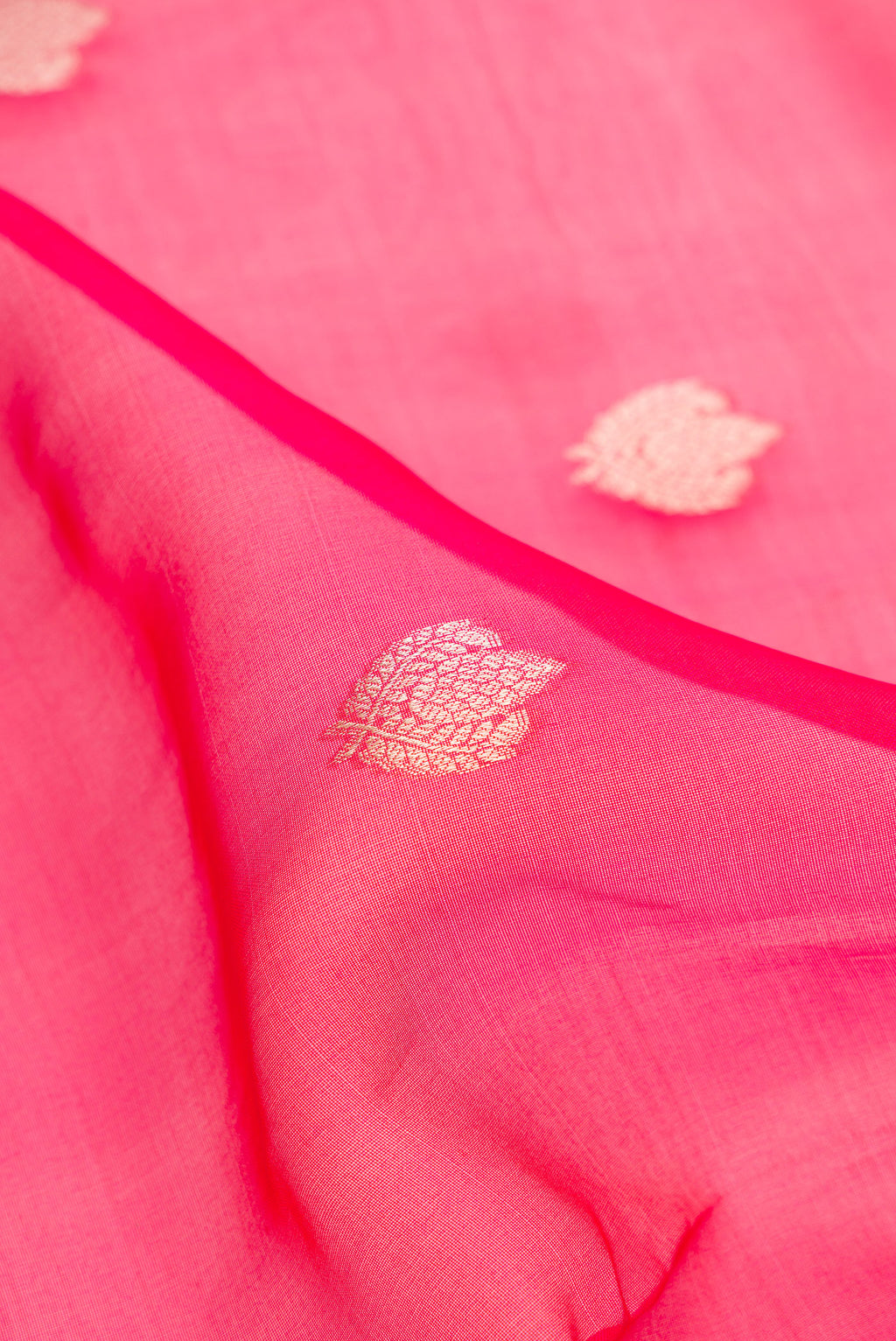 Close up of Pure Silk Dark Mauve Dual Tone Raw Saree with Zari Butta on the body and Zari Border.  displaying folds