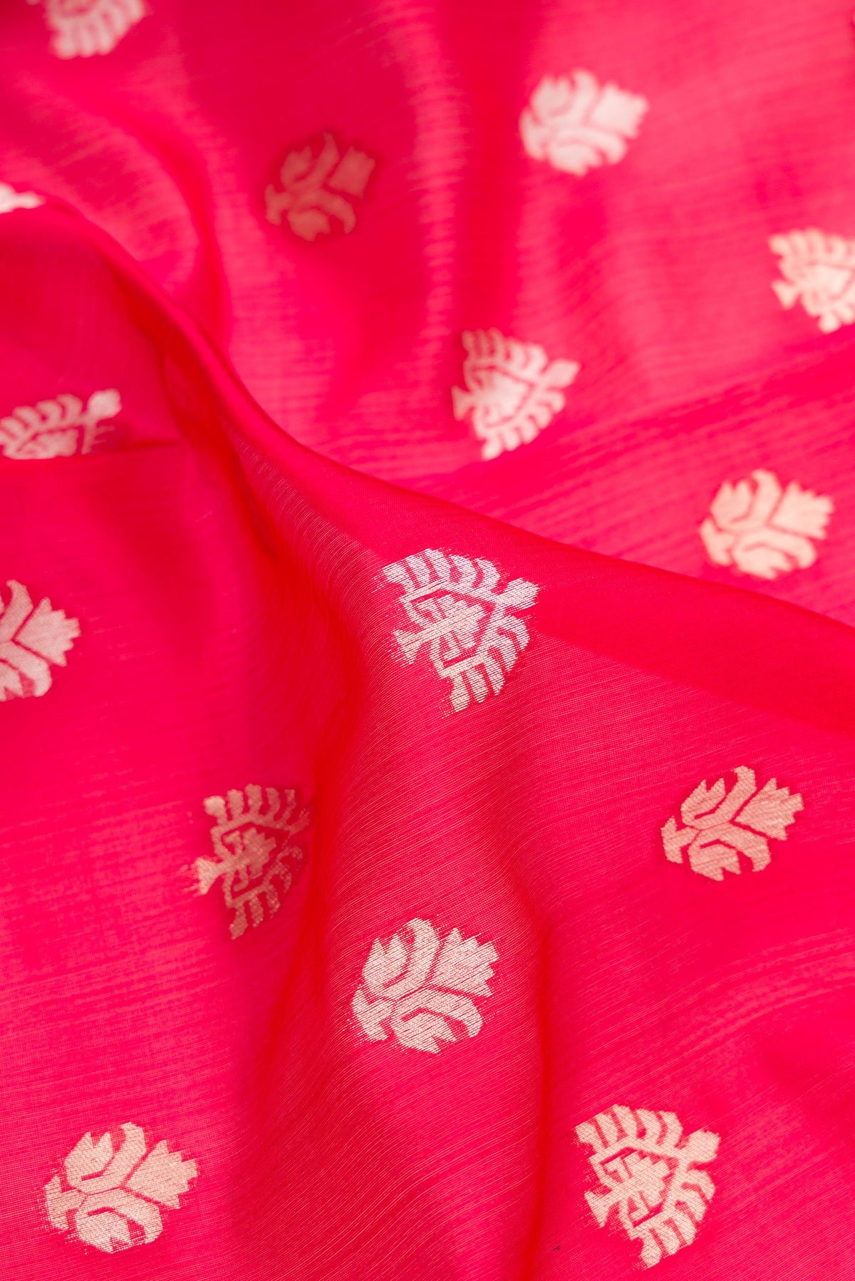 Close up of Pure Silk Red Dual Tone Banarasi Saree with Zari Butta on the body and Zari Border.  displaying folds
