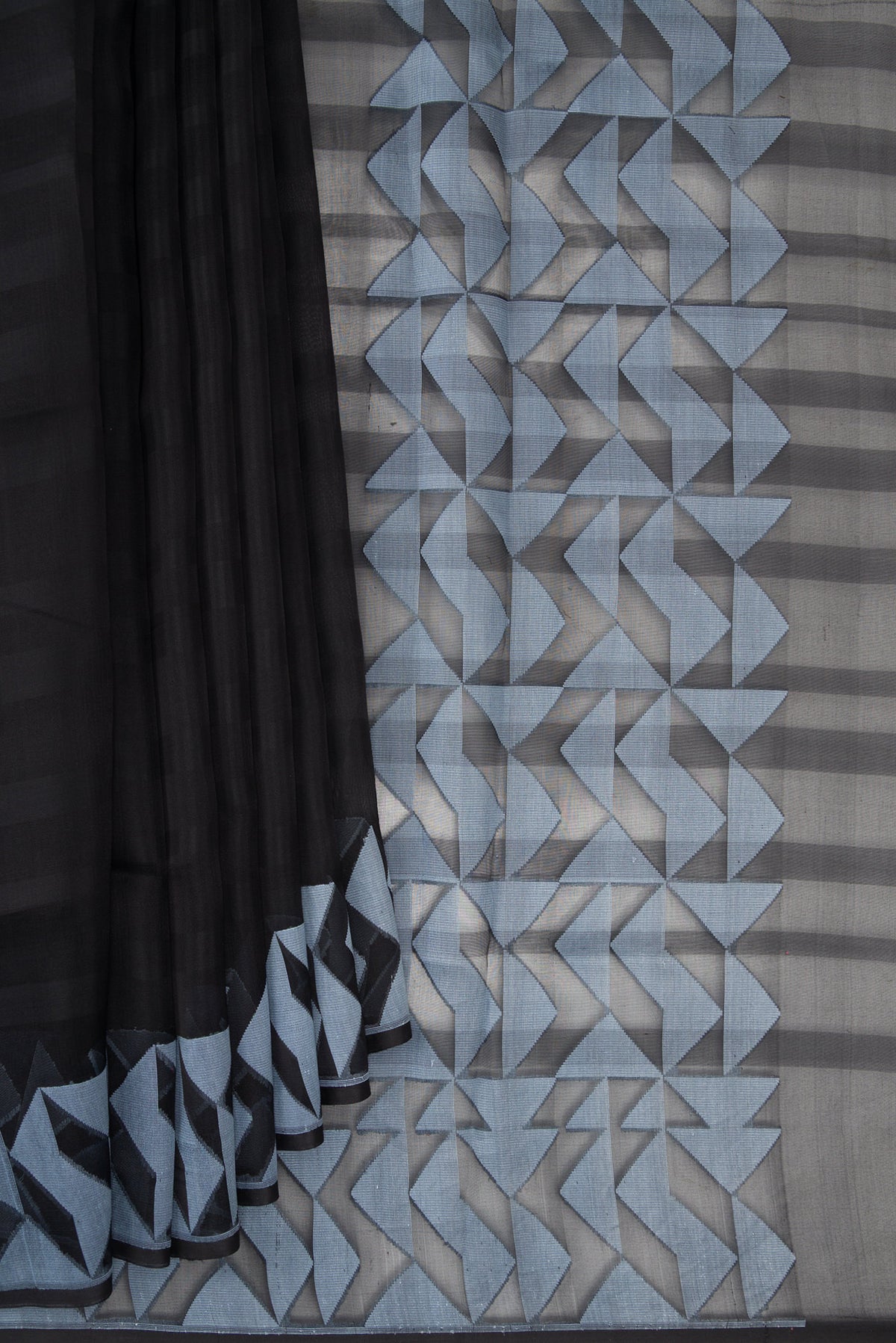 Pleats and pallu of Black Organza Saree with Stripes on the body and Fancy Border. 