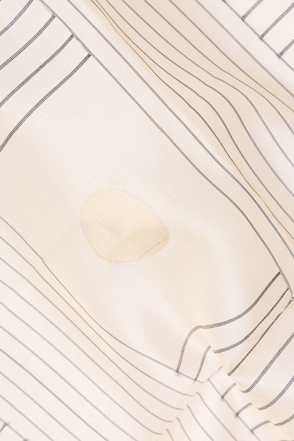 Close up of Cream Tussar Saree with Stripes on the body and Zari Border.  displaying folds