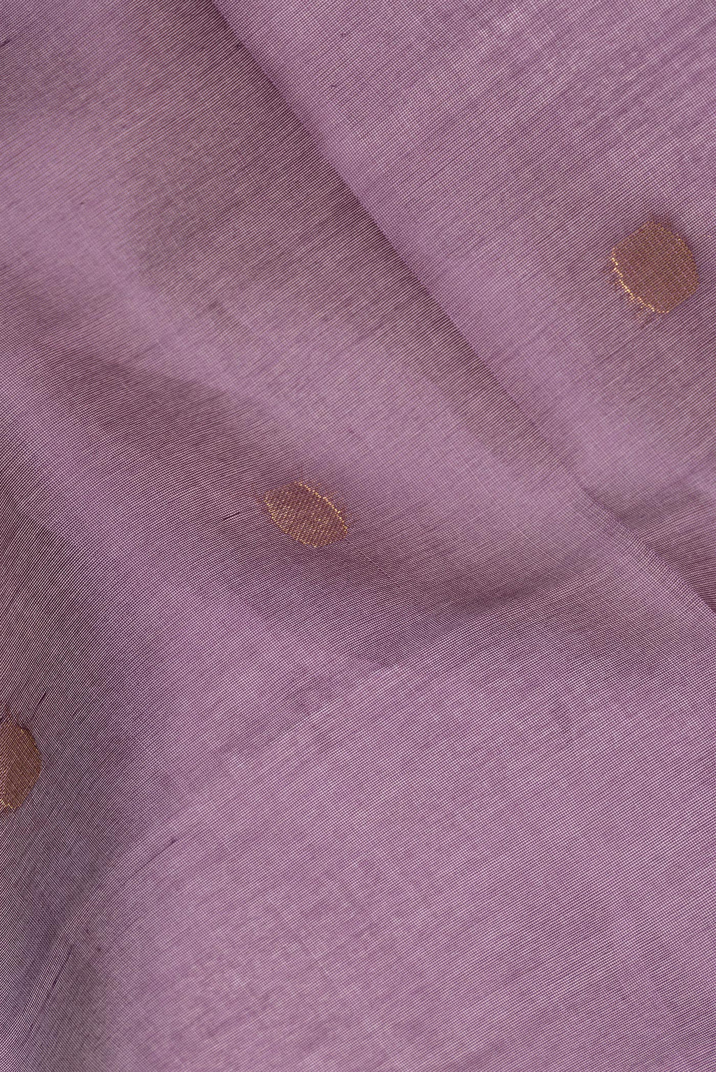 Close up of Mauve Tussar Saree with Zari Butta on the body and Zari Border.  displaying folds