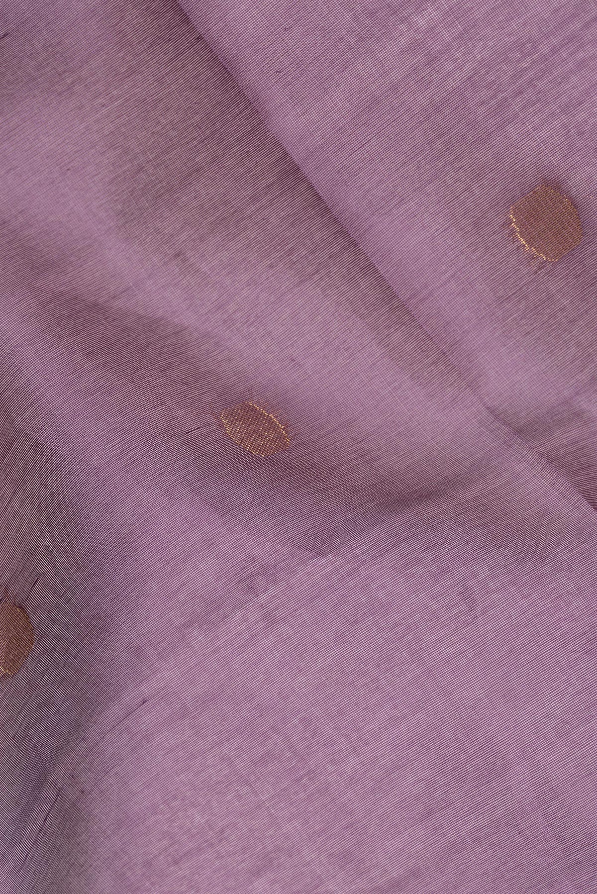 Close up of Mauve Tussar Saree with Zari Butta on the body and Zari Border.  displaying folds