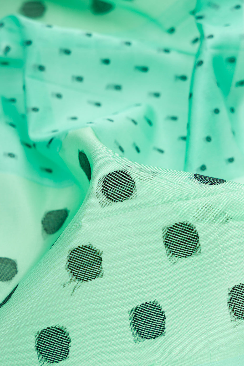 Close up of Pure Silk Sea Green Soft Saree with Thread Butta on the body and Without Border.  displaying folds