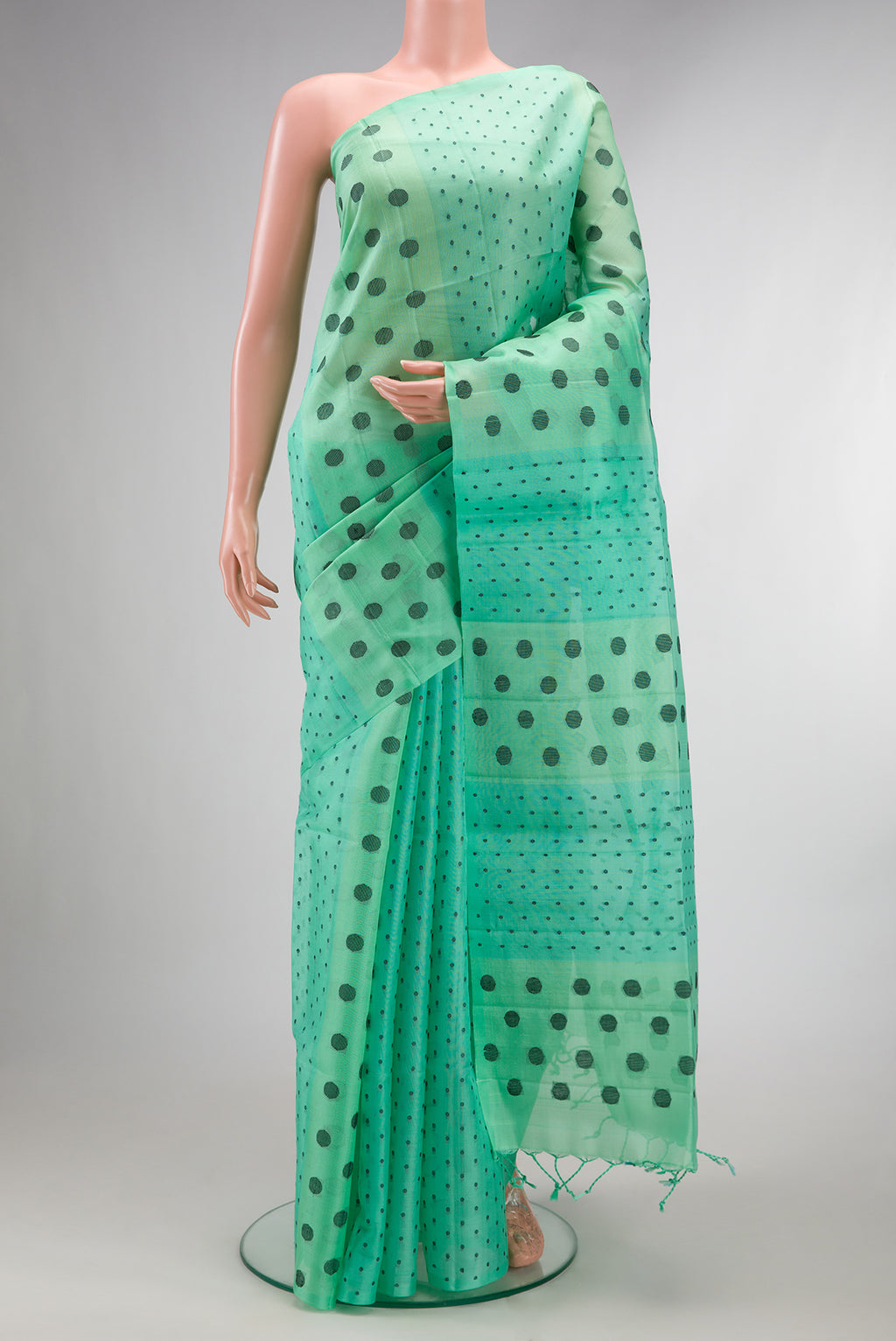 Pure Silk Sea Green Soft Saree with Thread Butta on the body and Without Border.  displayed on a mannequin
