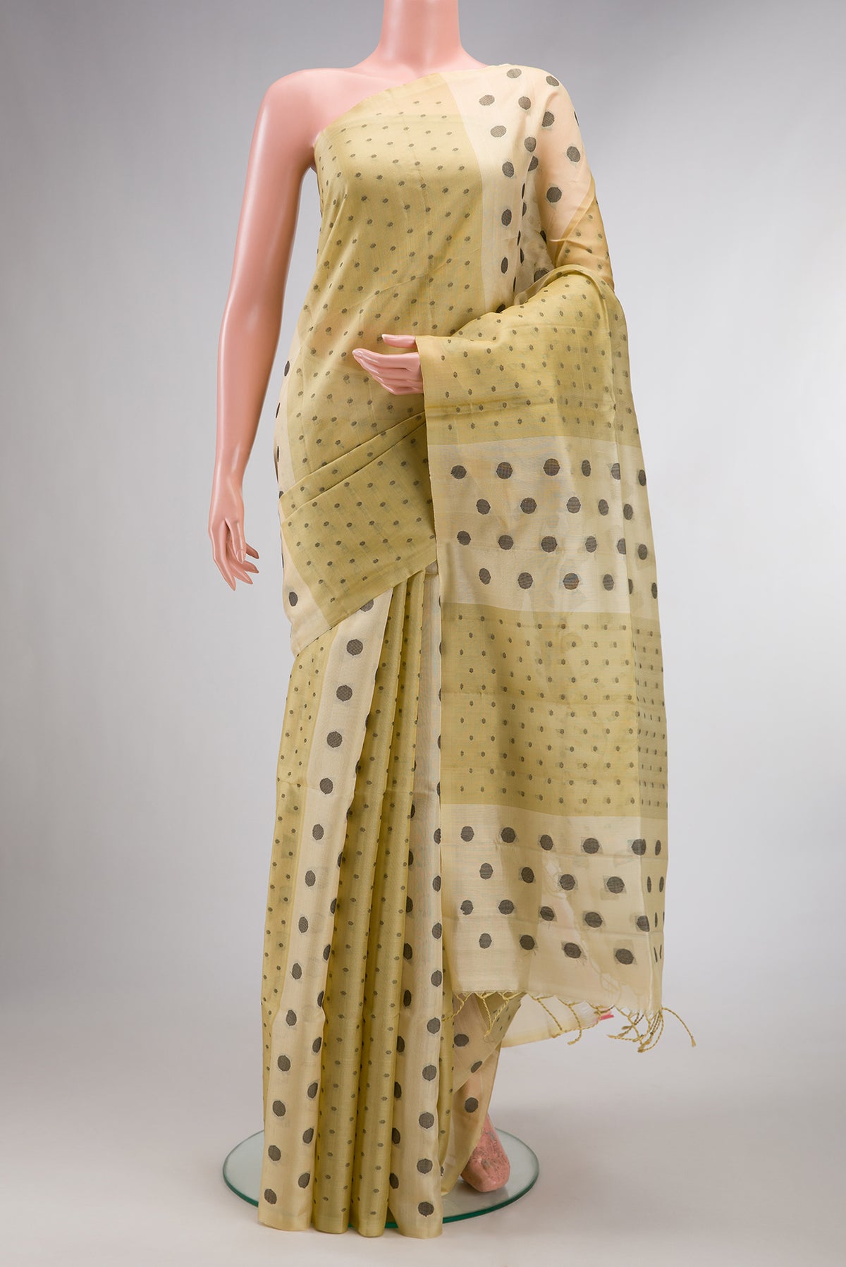 Pure Silk Sandal Soft Saree with Thread Butta on the body and Without Border.  displayed on a mannequin