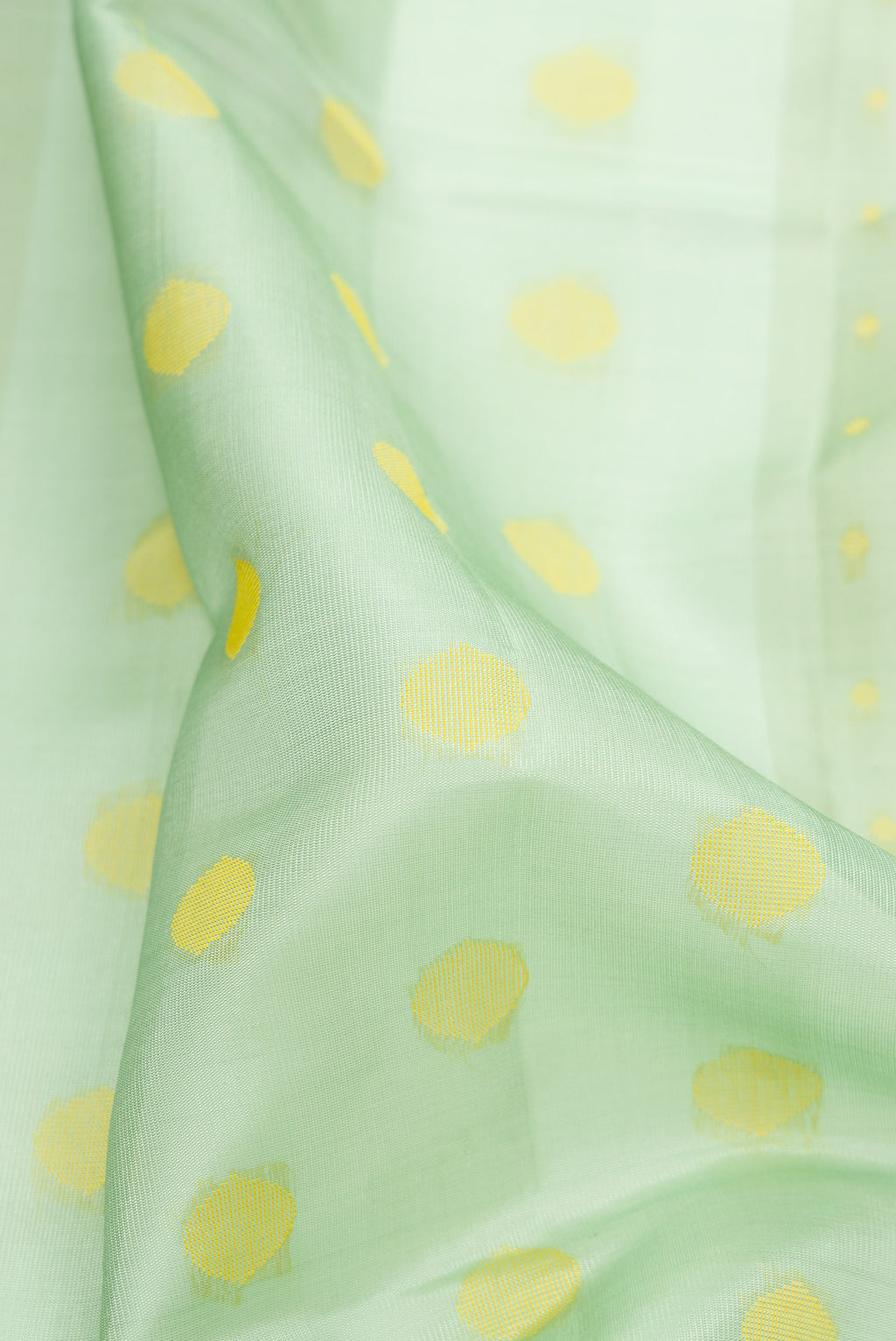 Close up of Pure Silk Pista Green Soft Saree with Thread Butta on the body and Without Border.  displaying folds
