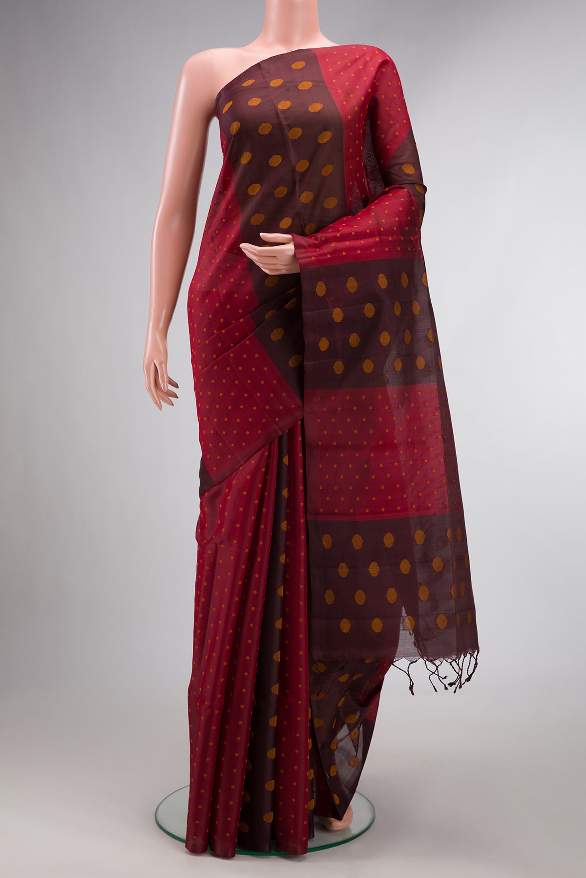 Pure Silk Maroon Dual Tone Organza Saree with Thread Butta on the body and Without Border.  displayed on a mannequin