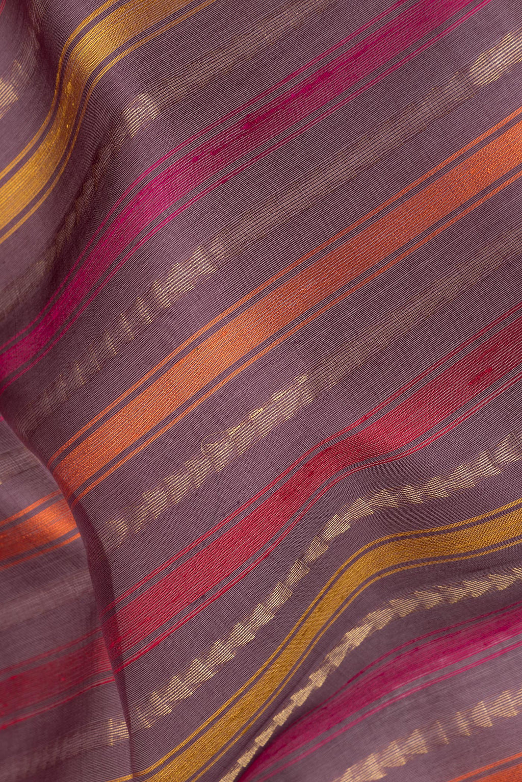 Close up of Pure Silk Purple Dual Tone Tussar Saree with Stripes on the body and Zari Border.  displaying folds