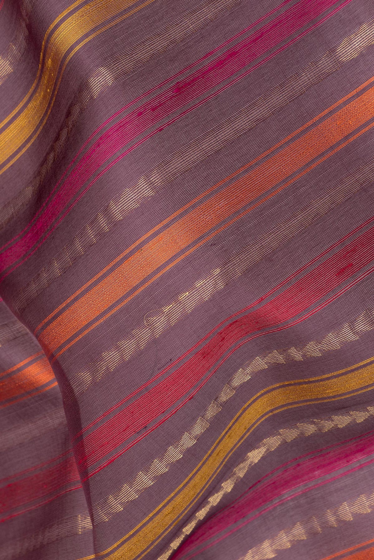 Close up of Pure Silk Purple Dual Tone Tussar Saree with Stripes on the body and Zari Border.  displaying folds