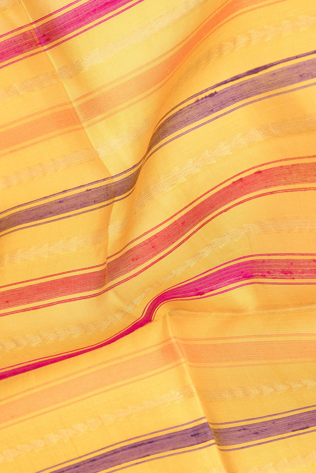 Close up of Pure Silk Mustard Dual Tone Tussar Saree with Stripes on the body and Zari Border.  displaying folds