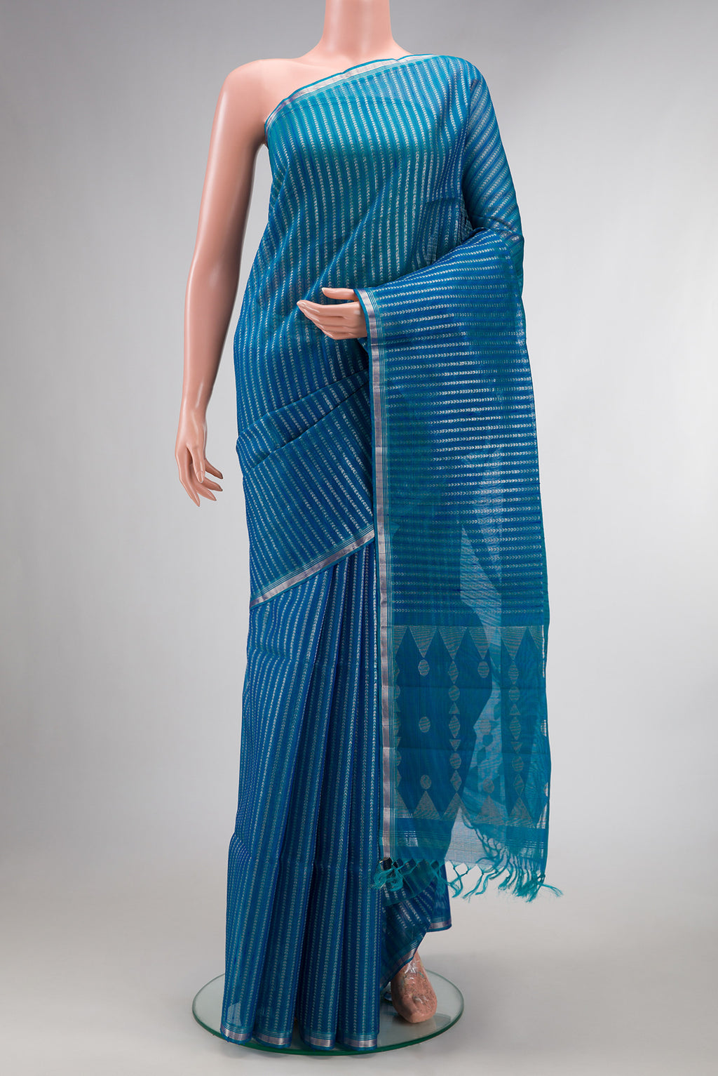 Peacock Blue Tussar Saree with Stripes on the body and Zari Border.  displayed on a mannequin