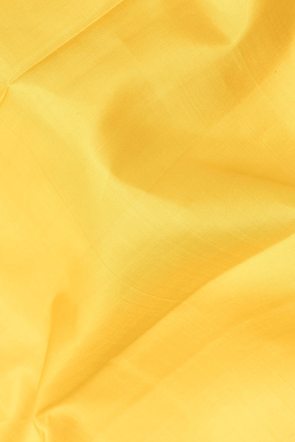 Close up of Pure Silk Mustard Dual Tone Kanjivaram Saree with Plain Body and Temple Border.  displaying folds
