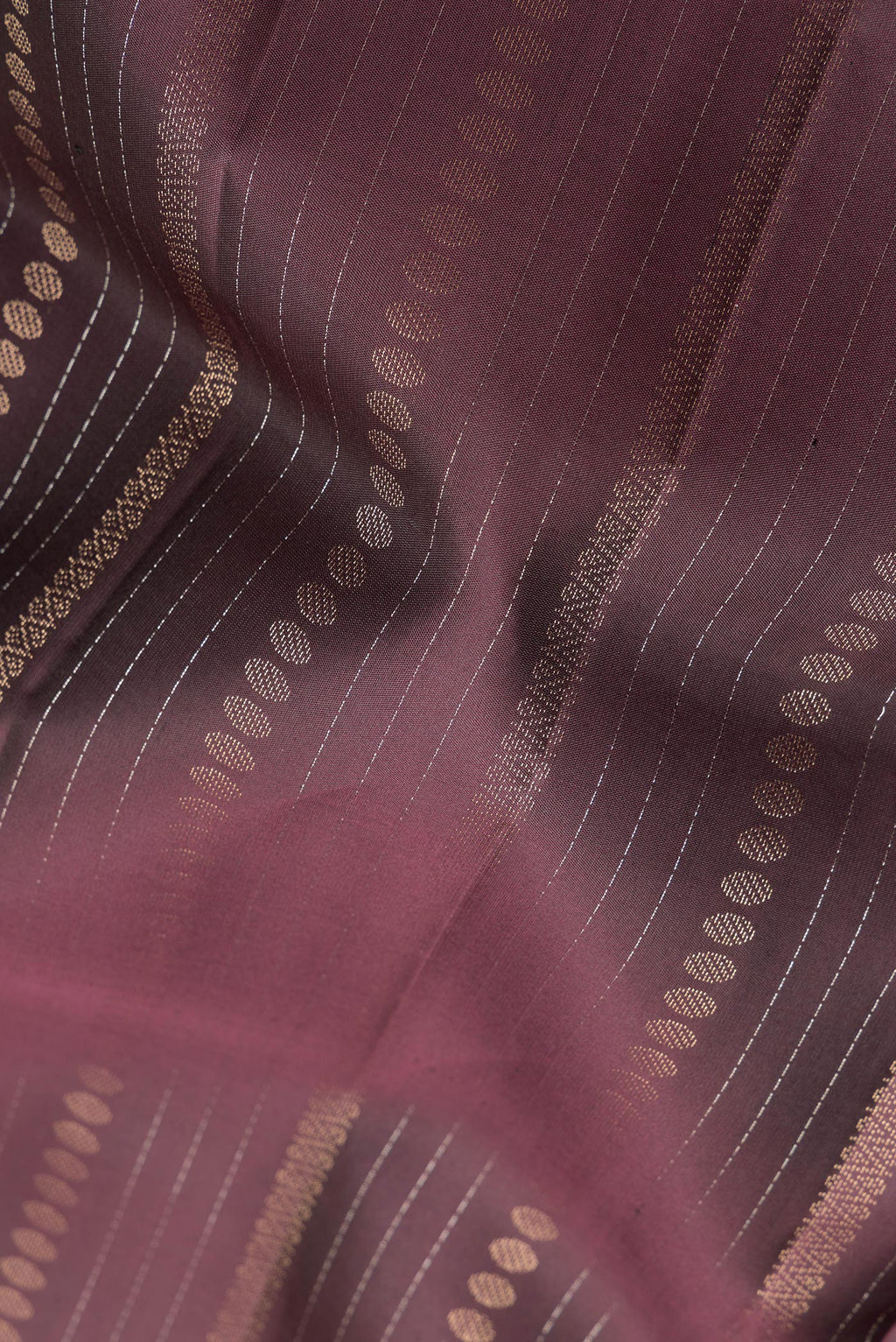 Close up of Pure Silk Coffee Brown Dual Tone Soft Saree with Stripes on the body and Without Border.  displaying folds