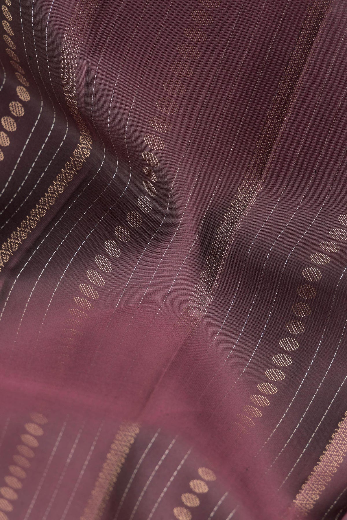 Close up of Pure Silk Coffee Brown Dual Tone Soft Saree with Stripes on the body and Without Border.  displaying folds