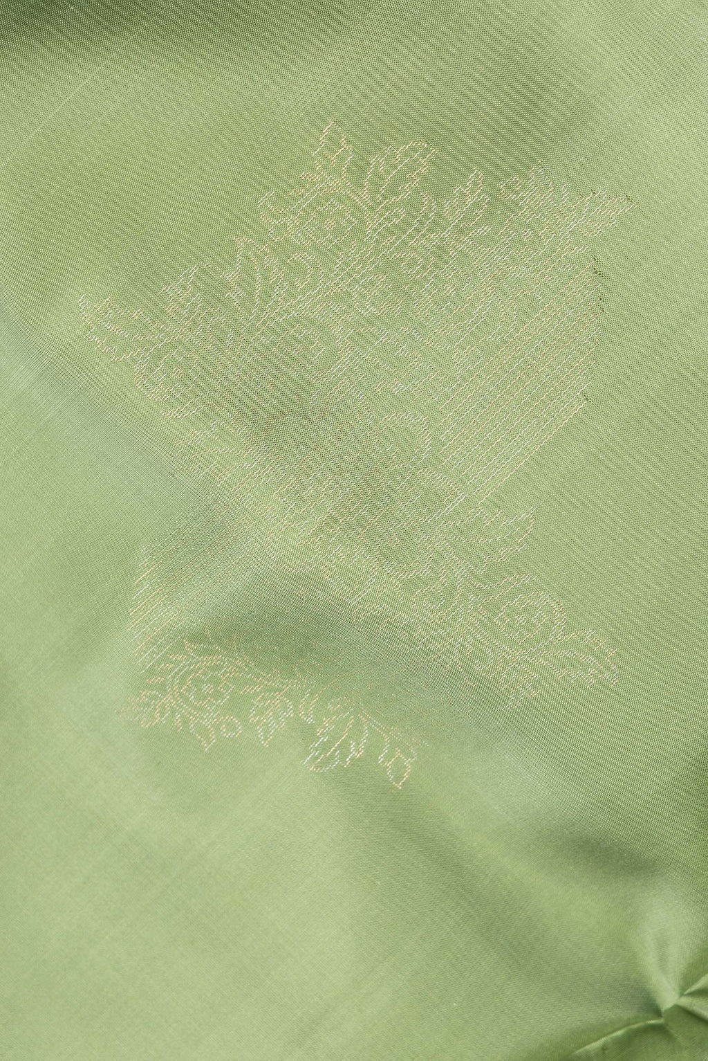 Close up of Pure Silk Green Dual Tone Soft Saree with Zari Butta on the body and Without Border.  displaying folds