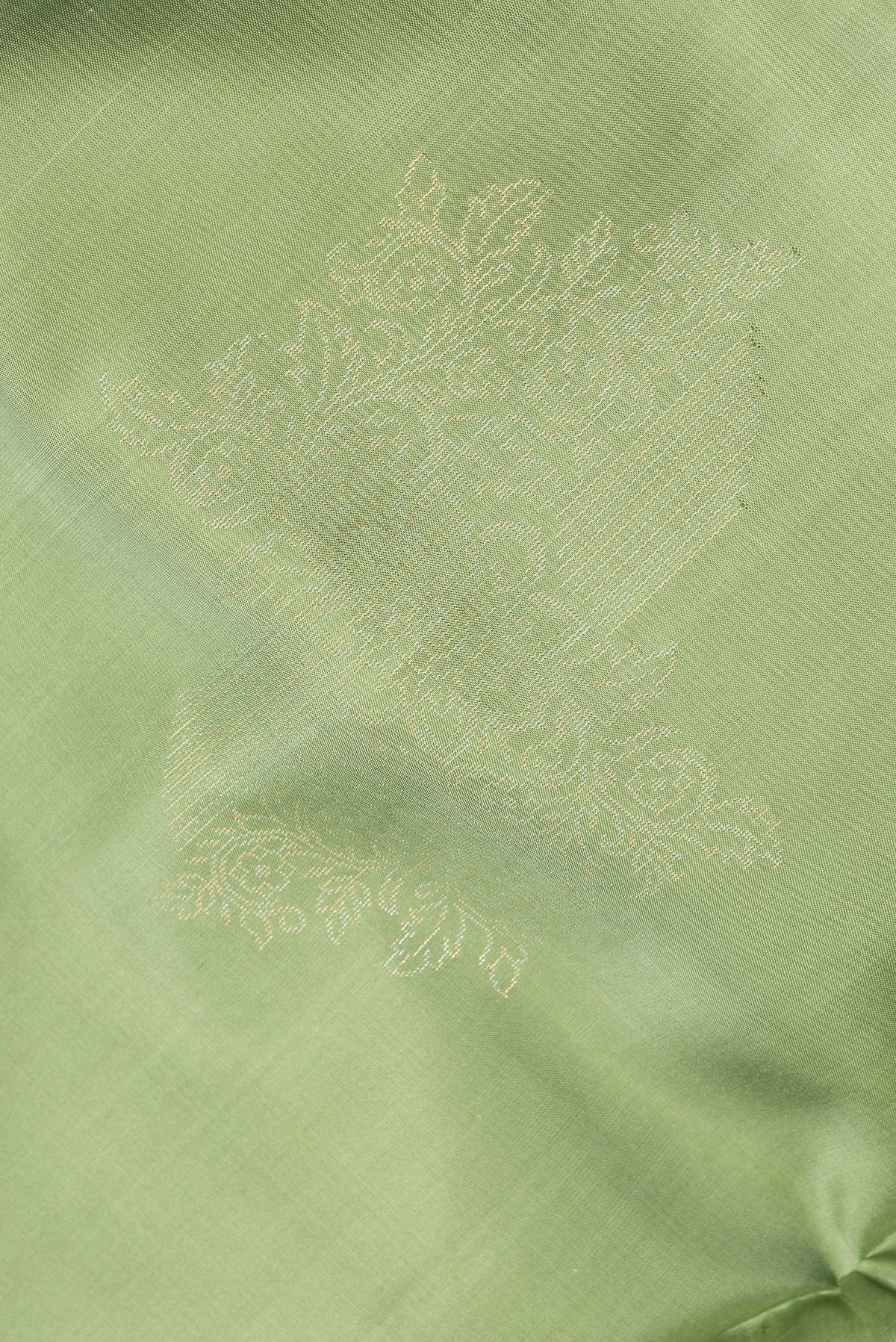 Close up of Pure Silk Green Dual Tone Soft Saree with Zari Butta on the body and Without Border.  displaying folds