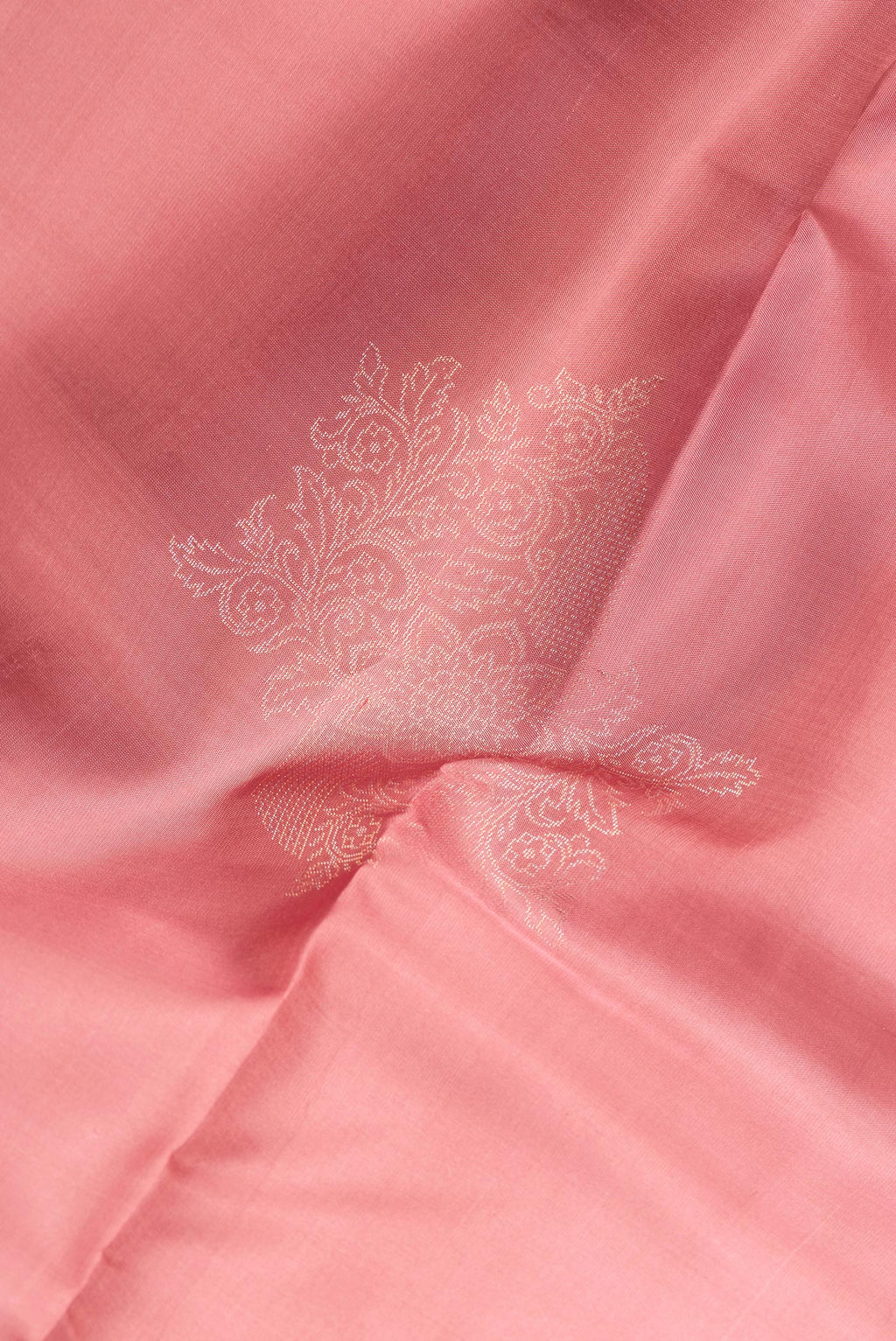 Close up of Pure Silk Rose Gold Dual Tone Soft Saree with Zari Butta on the body and Without Border.  displaying folds