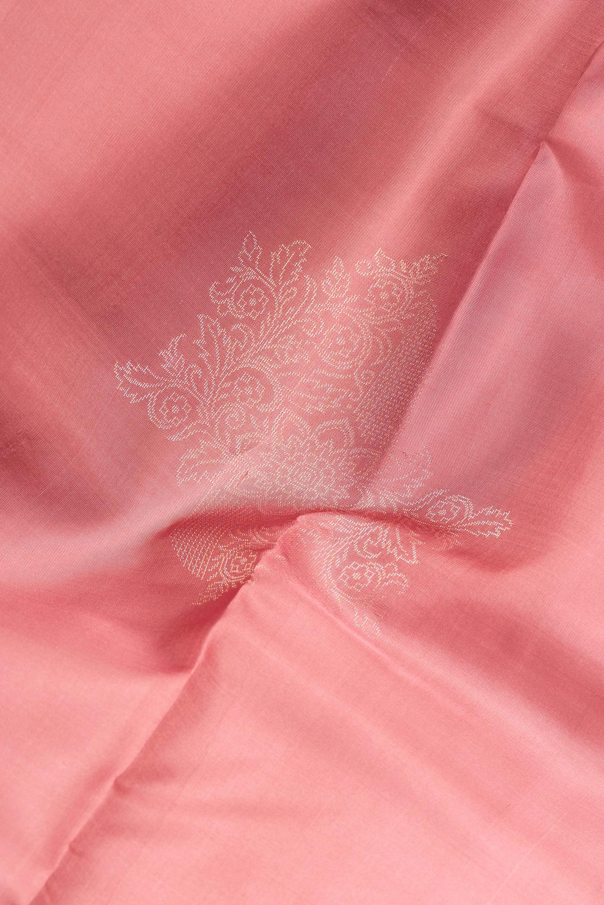 Close up of Pure Silk Rose Gold Dual Tone Soft Saree with Zari Butta on the body and Without Border.  displaying folds