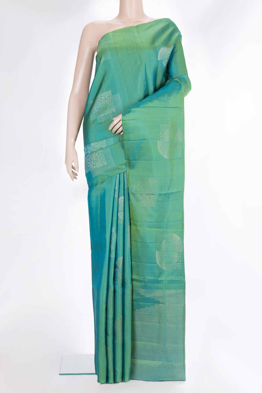 Pure Silk Green Dual Tone Soft Saree with Zari Butta on the body and Without Border.  displayed on a mannequin