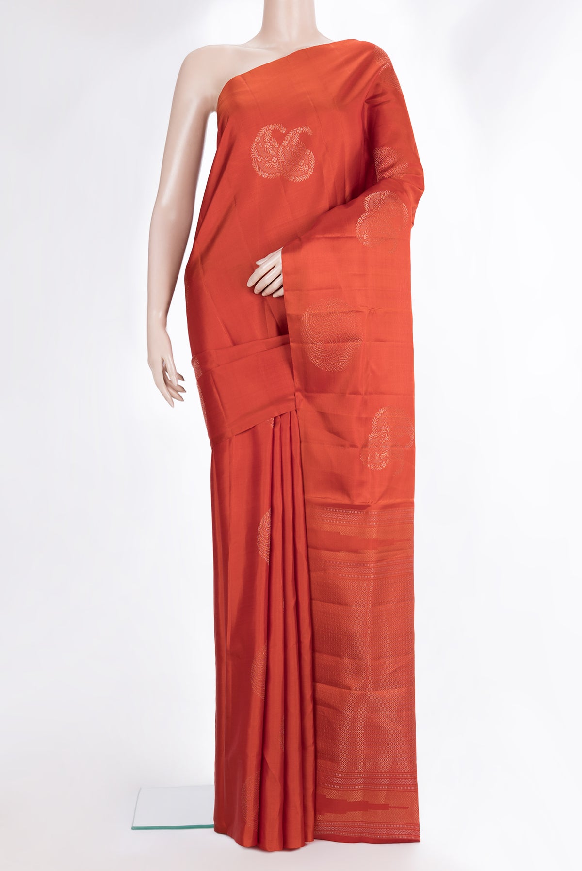 Pure Silk Brick Orange Dual Tone Soft Saree with Zari Butta on the body and Without Border.  displayed on a mannequin