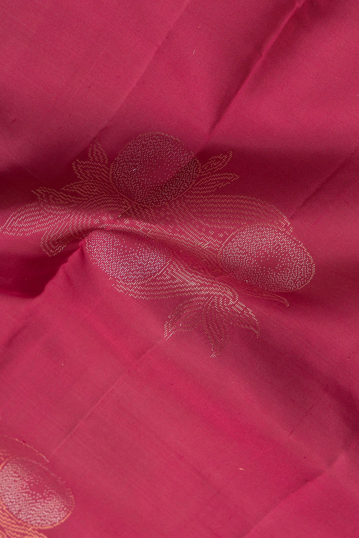 Close up of Pure Silk Maroon Dual Tone Soft Saree with Zari Butta on the body and Without Border.  displaying folds