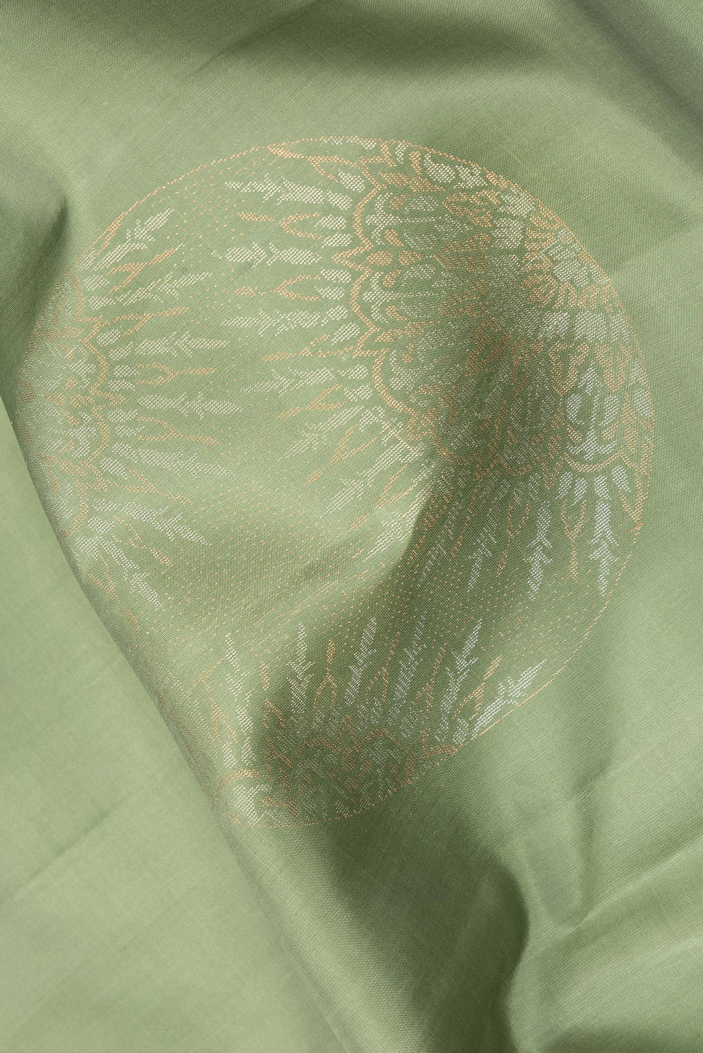Close up of Pure Silk Pista Green Dual Tone Soft Saree with Zari Butta on the body and Without Border.  displaying folds