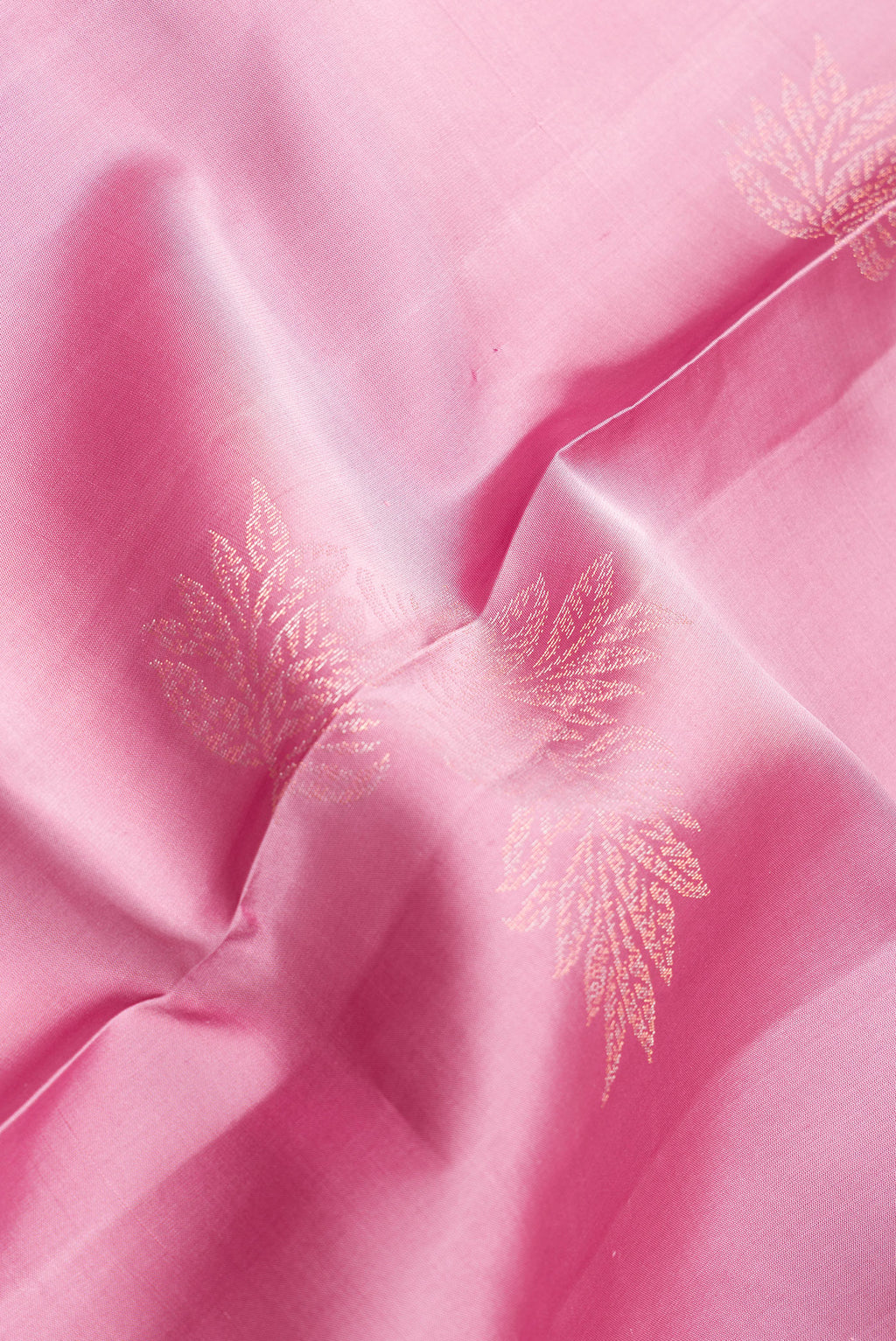 Close up of Pure Silk Pink Dual Tone Soft Saree with Zari Butta on the body and Without Border.  displaying folds
