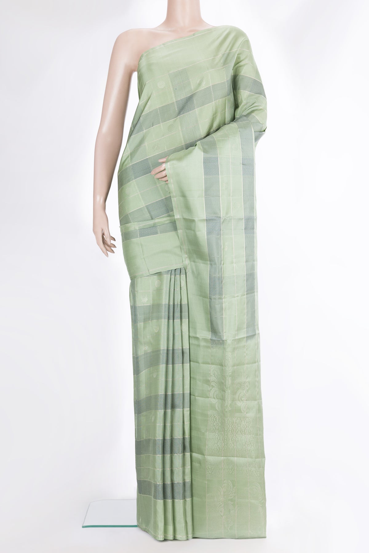 Pure Silk Pista Green Dual Tone Soft Saree with Checked design on the body and Zari Border.  displayed on a mannequin