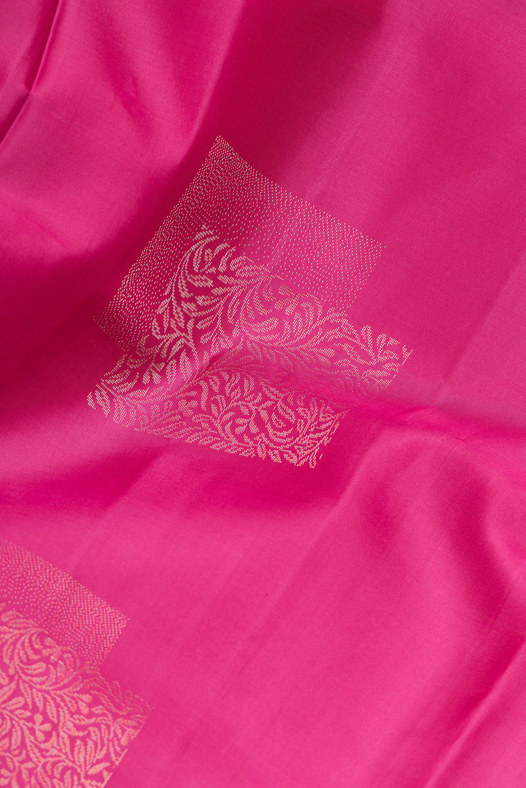 Close up of Pure Silk Magenta Dual Tone Soft Saree with Zari Butta on the body and Without Border.  displaying folds