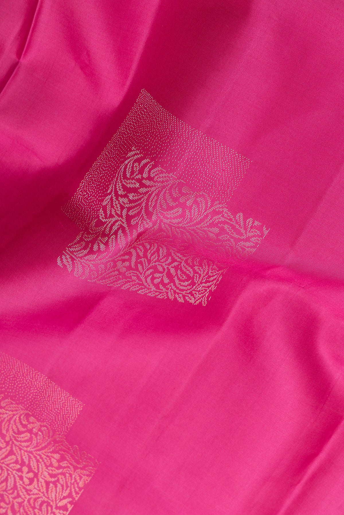 Close up of Pure Silk Magenta Dual Tone Soft Saree with Zari Butta on the body and Without Border.  displaying folds