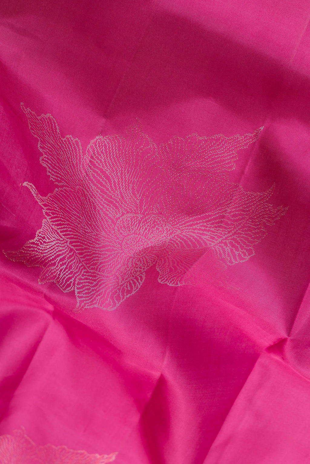 Close up of Pure Silk Magenta Dual Tone Soft Saree with Zari Butta on the body and Without Border.  displaying folds