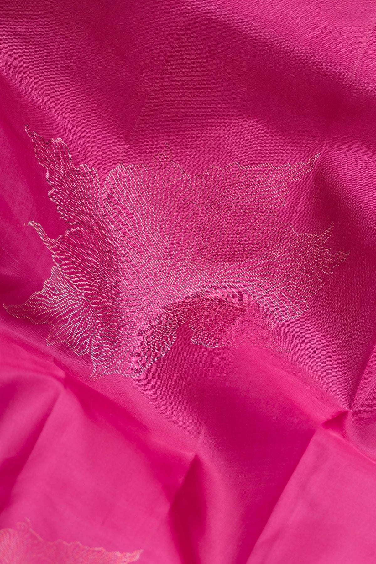 Close up of Pure Silk Magenta Dual Tone Soft Saree with Zari Butta on the body and Without Border.  displaying folds