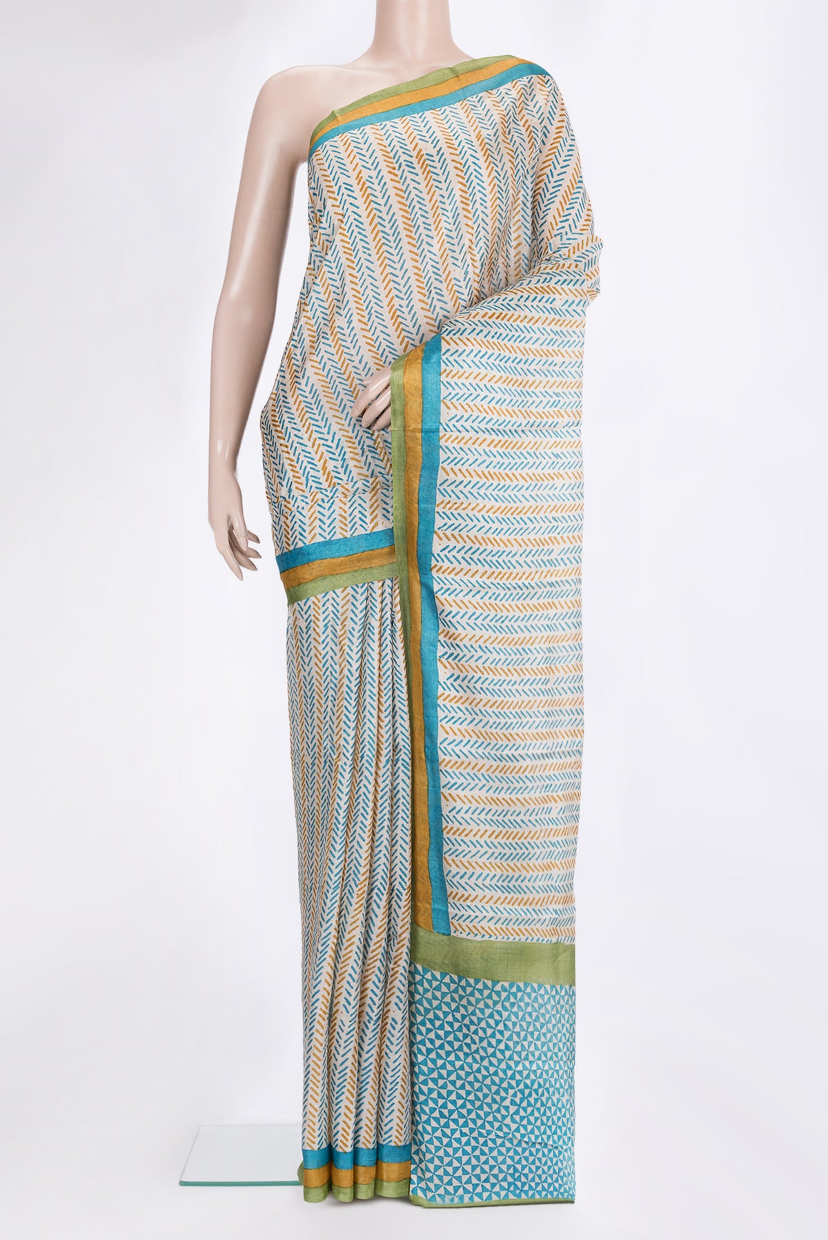 Beige Tussar Saree with Printed design on the body and Printed Border.  displayed on a mannequin