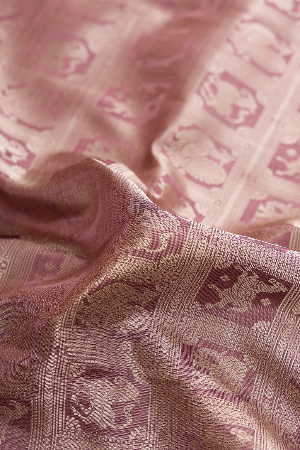 Close up of Pure Silk Pure Zari Mauve Kanjivaram Saree with Zari Brocade on the body and Fancy Border.  displaying folds
